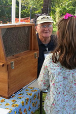 Leroy Cronkhite Sr. sharing and observation hive at the Farmington Fair