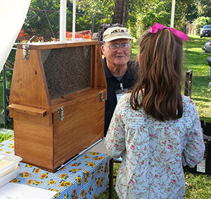 Leroy Cronkhite Sr. sharing and observation hive at the Farmington Fair