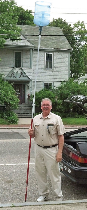 Dan Gray proudly displays his handy swarm grabber, fabricated from a heavy duty water jug and painter’s extension pole.
