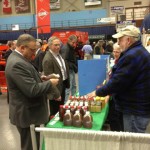 Governor LePage at the MSBA booth at the 2014 Agricultural Trade Show. Nick Kelley (Western Maine Beekeepers Association) shows him some good Maine honey!