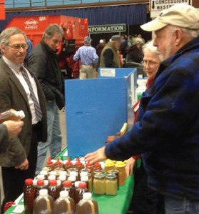MSBA booth at Maine’s 2014 Agricultural Trade Show. Nick Kelley (Western Maine Beekeepers Association) shows a sampling of Maine honey.